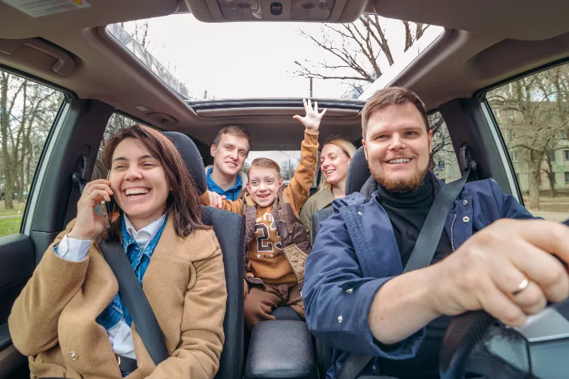 Happy family enjoying a road trip together in a car