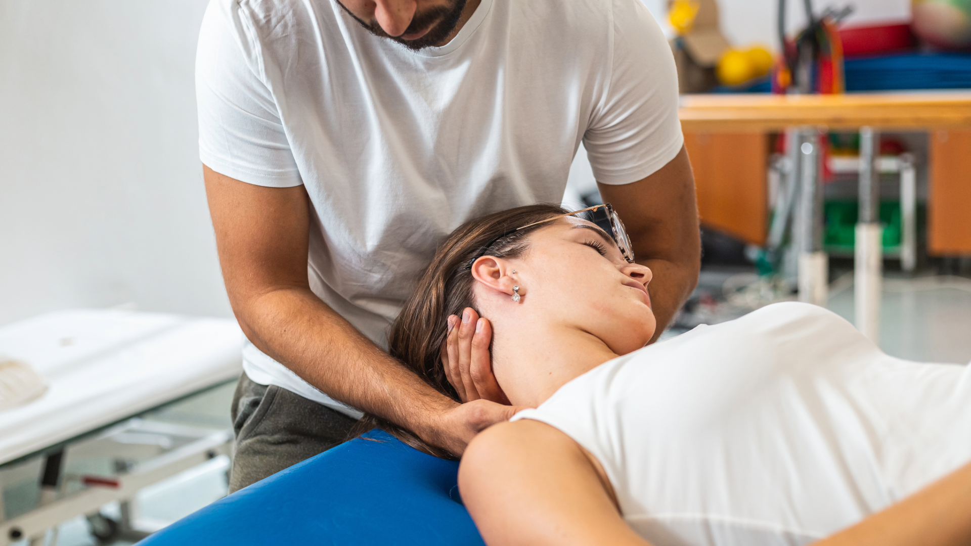 chiropractor performing a neck adjustment on a patient
